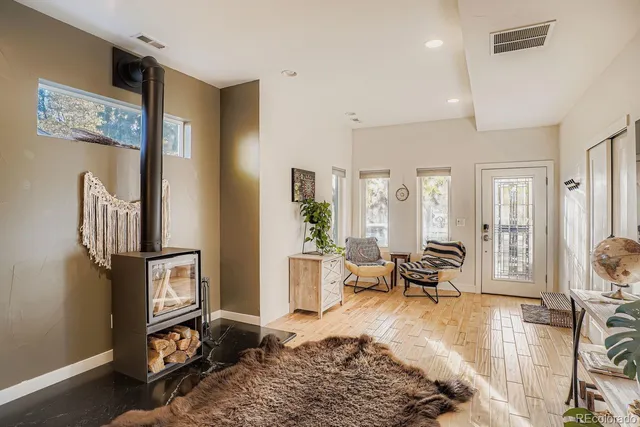 a living room with furniture wooden floor and a window