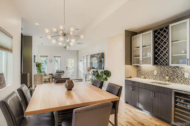 a view of a a dining room with furniture window and wooden floor