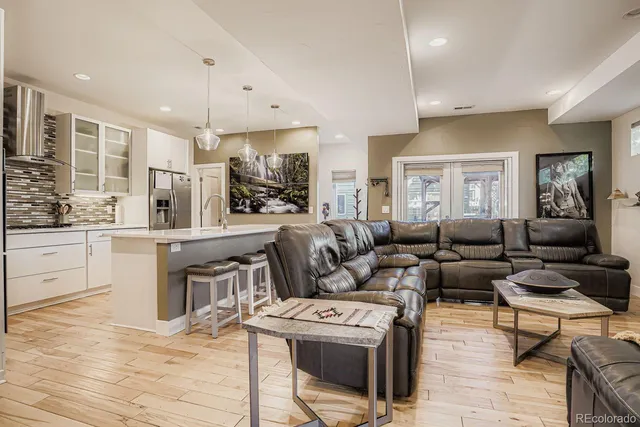 a living room with furniture and a wooden floor