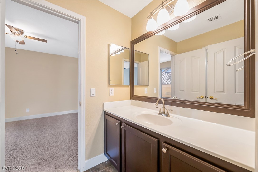 271 Pointe Ranier Avenue Henderson, NV 89012 - Photo 21 of 26 This clean bathroom features a large vanity with ample storage, creating a functional space.