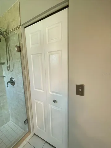 a bathroom with a glass door shower