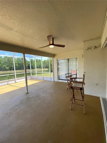 a view of a livingroom with wooden floor and a iron fence