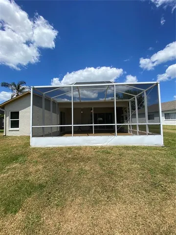 a view of a house with a large window and plants