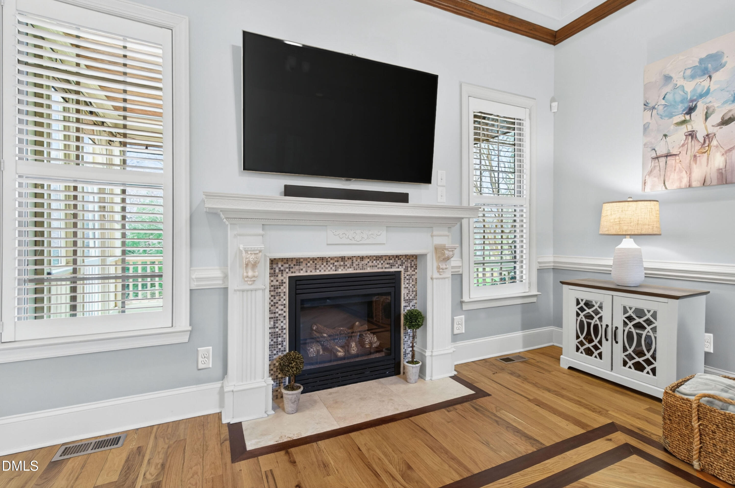 691 Hawthorne Place Creedmoor, NC 27522 - Photo 15 of 84 a living room with a fireplace a flat screen tv and a window