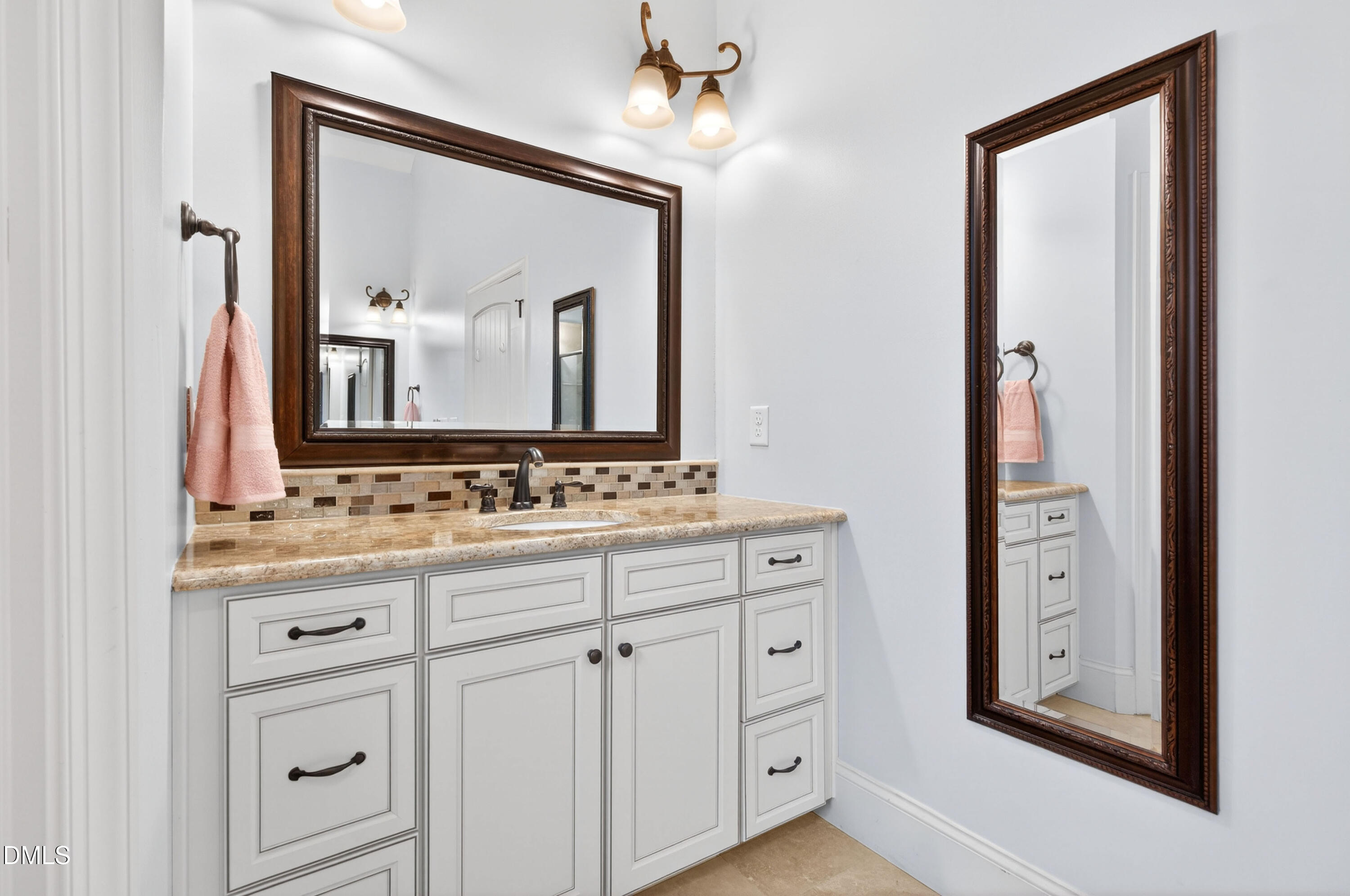 691 Hawthorne Place Creedmoor, NC 27522 - Photo 40 of 84 a bathroom with a double vanity sink and a mirror