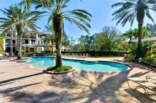 a swimming pool with outdoor seating and yard