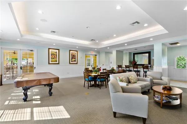a living room with furniture a rug and a table