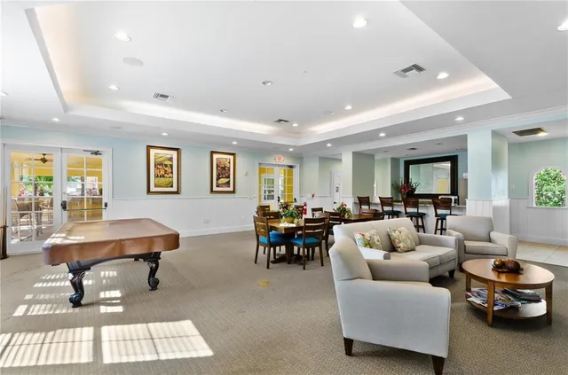 a living room with furniture a rug and a table