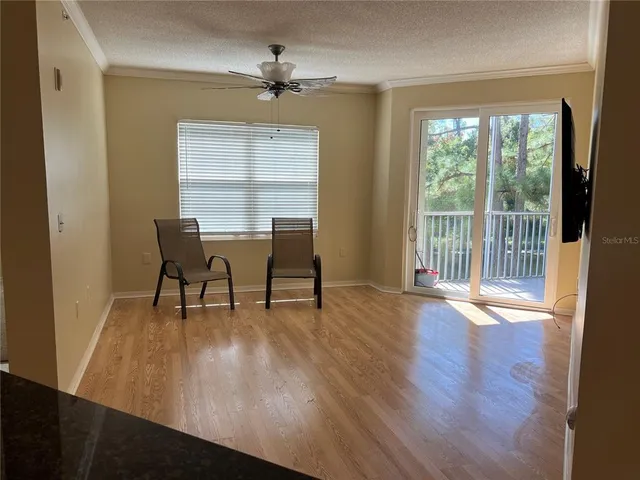 a view of a work space with wooden floor and a floor to ceiling window