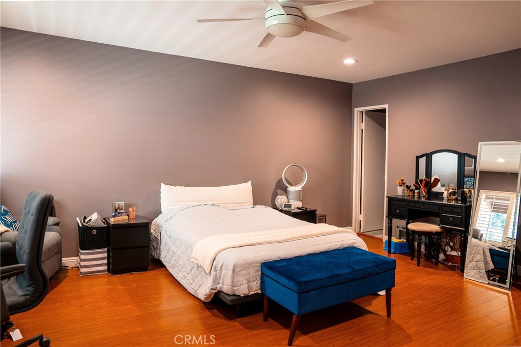 9759 Vía Roma Burbank, CA 91504 - Photo 14 of 29 a bedroom with a bed table chair and a ceiling fan
