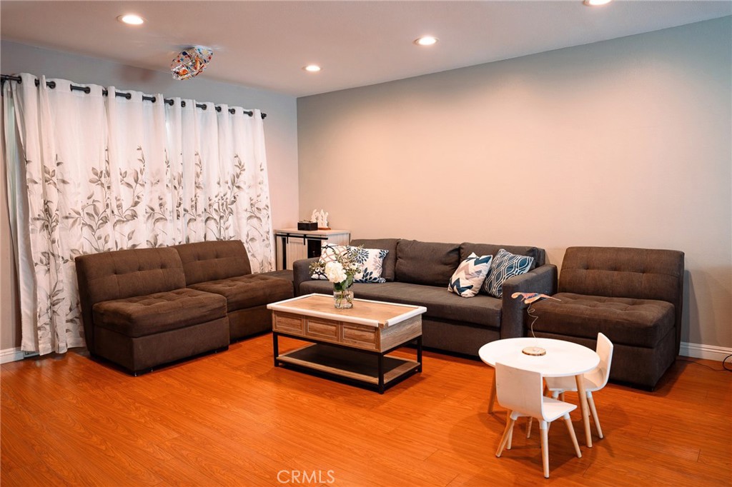 9759 Vía Roma Burbank, CA 91504 - Photo 3 of 29 a living room with furniture and a chandelier