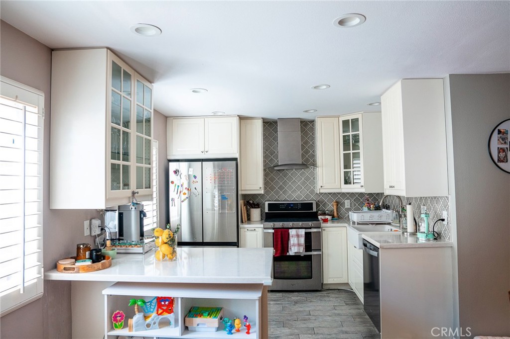 9759 Vía Roma Burbank, CA 91504 - Photo 5 of 29 a kitchen with a refrigerator and a stove top oven