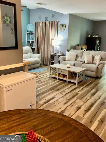 a living room with furniture and a rug