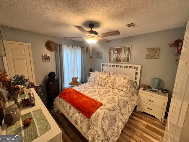a bedroom with bed and a chandelier