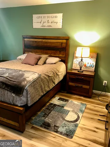 a bed sitting in a bedroom next to a window