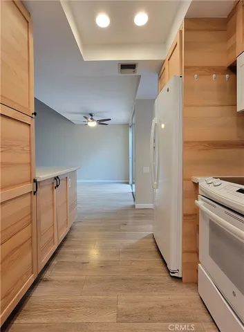 a view of a house with garden and a tree