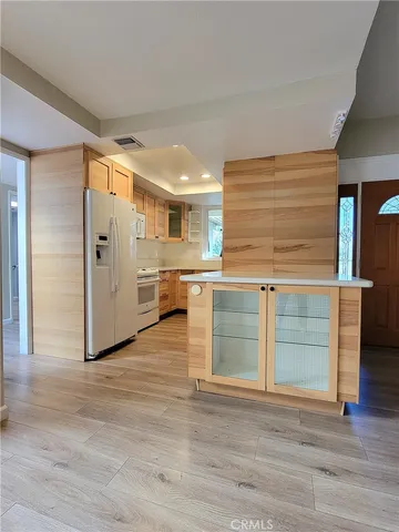 a kitchen with white cabinets and sink