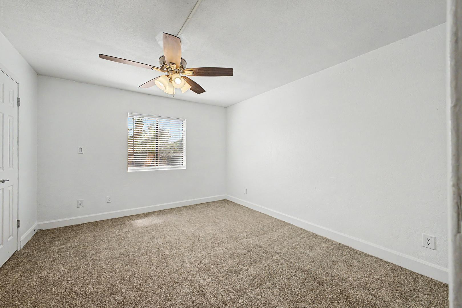 3825 East Camelback Road, Unit 144 Phoenix, AZ 85018 - Photo 12 of 35 an empty room with windows and fan