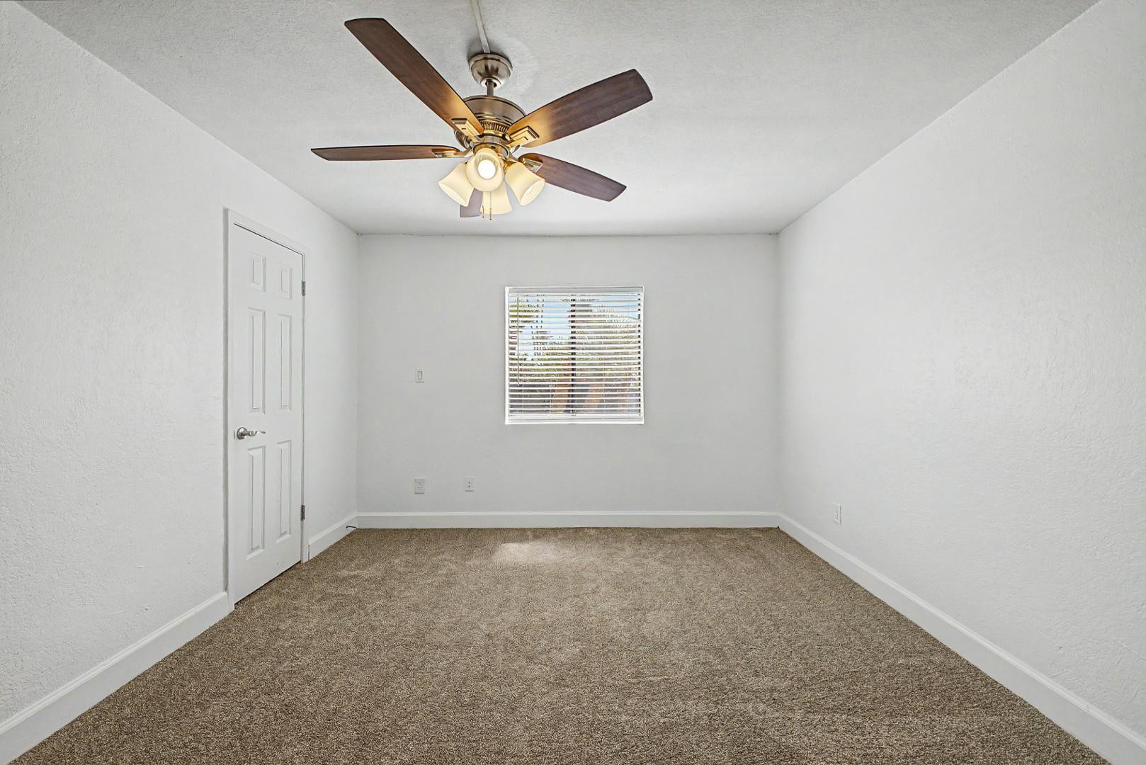 3825 East Camelback Road, Unit 144 Phoenix, AZ 85018 - Photo 14 of 35 an empty room with windows and fan