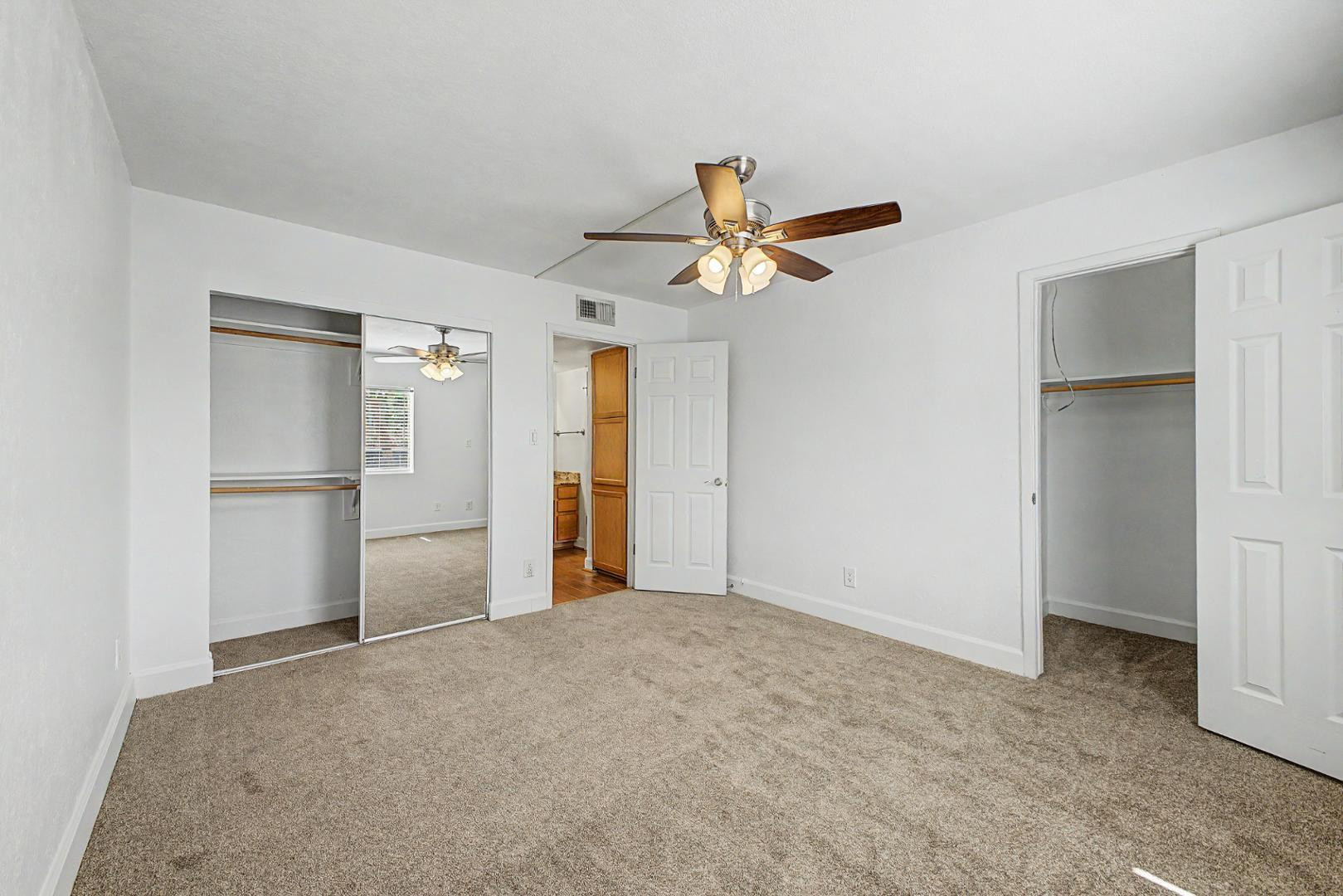 3825 East Camelback Road, Unit 144 Phoenix, AZ 85018 - Photo 15 of 35 a view of a big room with wooden floor and a kitchen