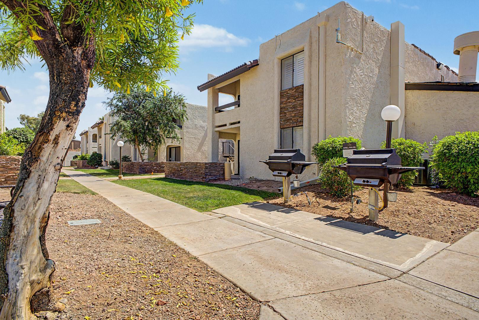 3825 East Camelback Road, Unit 144 Phoenix, AZ 85018 - Photo 31 of 35 a view of backyard with a table and chairs under an umbrella