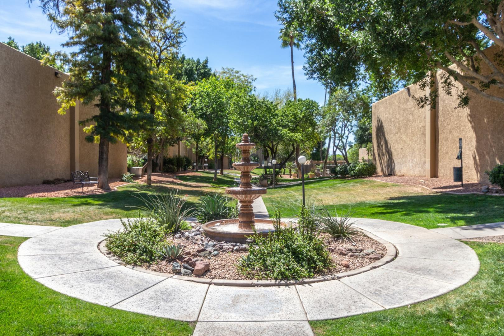 3825 East Camelback Road, Unit 144 Phoenix, AZ 85018 - Photo 34 of 35 a view of a fountain in the yard with palm trees