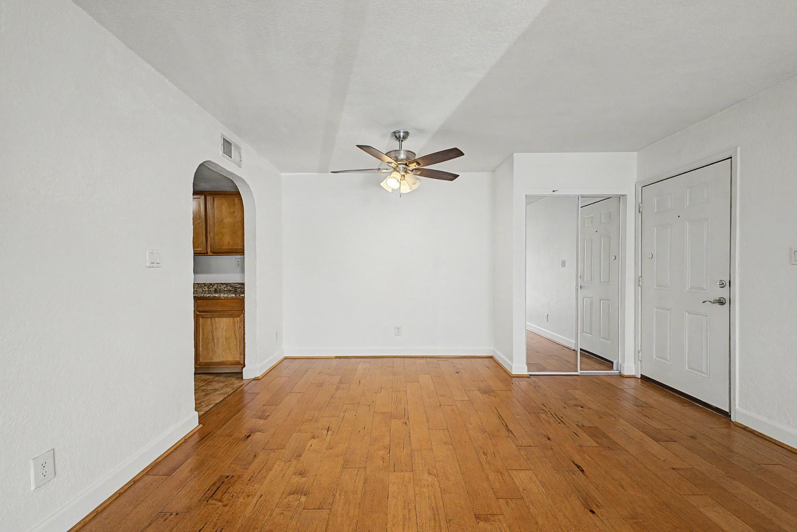 3825 East Camelback Road, Unit 144 Phoenix, AZ 85018 - Photo 6 of 35 a view of a room with wooden floor and white walls
