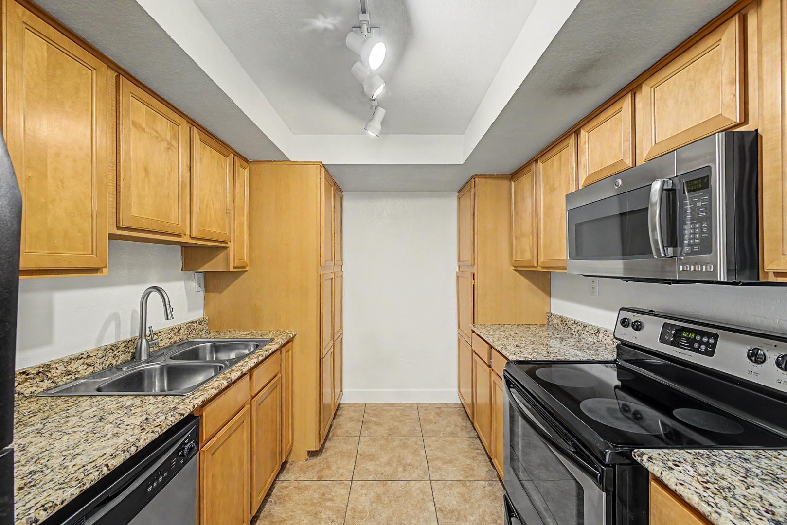 3825 East Camelback Road, Unit 144 Phoenix, AZ 85018 - Photo 10 of 35 a kitchen with stainless steel appliances granite countertop a stove and a sink