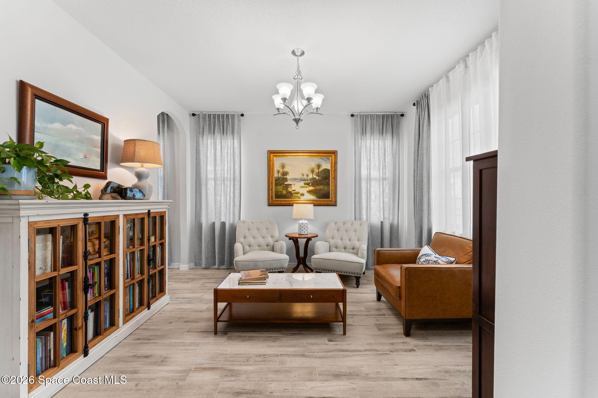 3236 Becorden Way Melbourne, FL 32940 - Photo 12 of 40 a bedroom with furniture and a chandelier