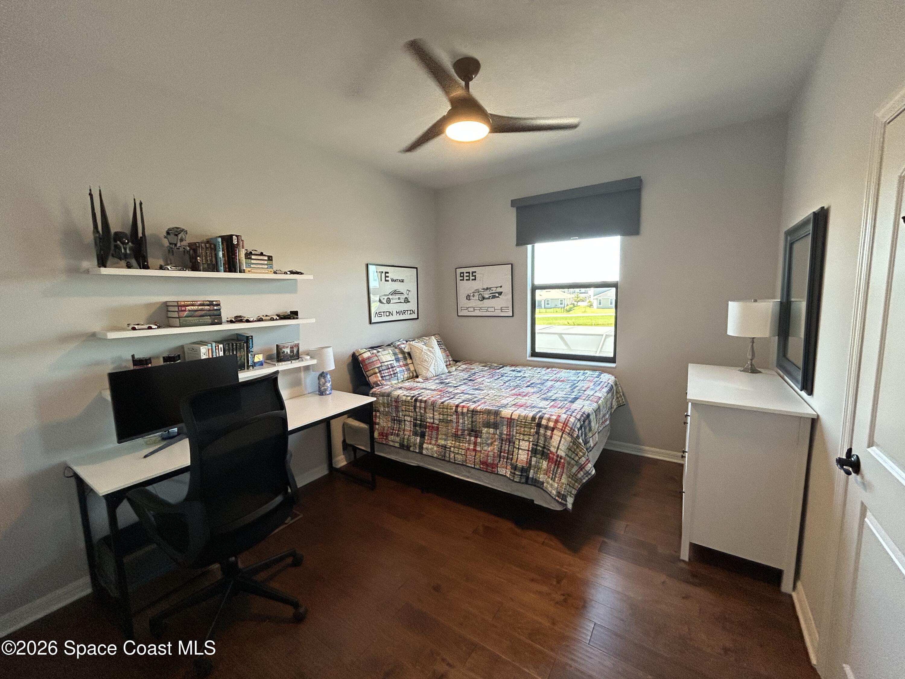 3236 Becorden Way Melbourne, FL 32940 - Photo 15 of 40 a bedroom with a bed and a desk in it