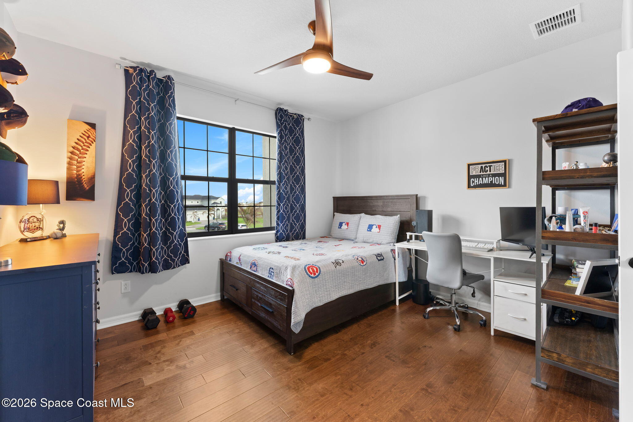 3236 Becorden Way Melbourne, FL 32940 - Photo 16 of 40 a bedroom with a bed next to a window and a chandelier