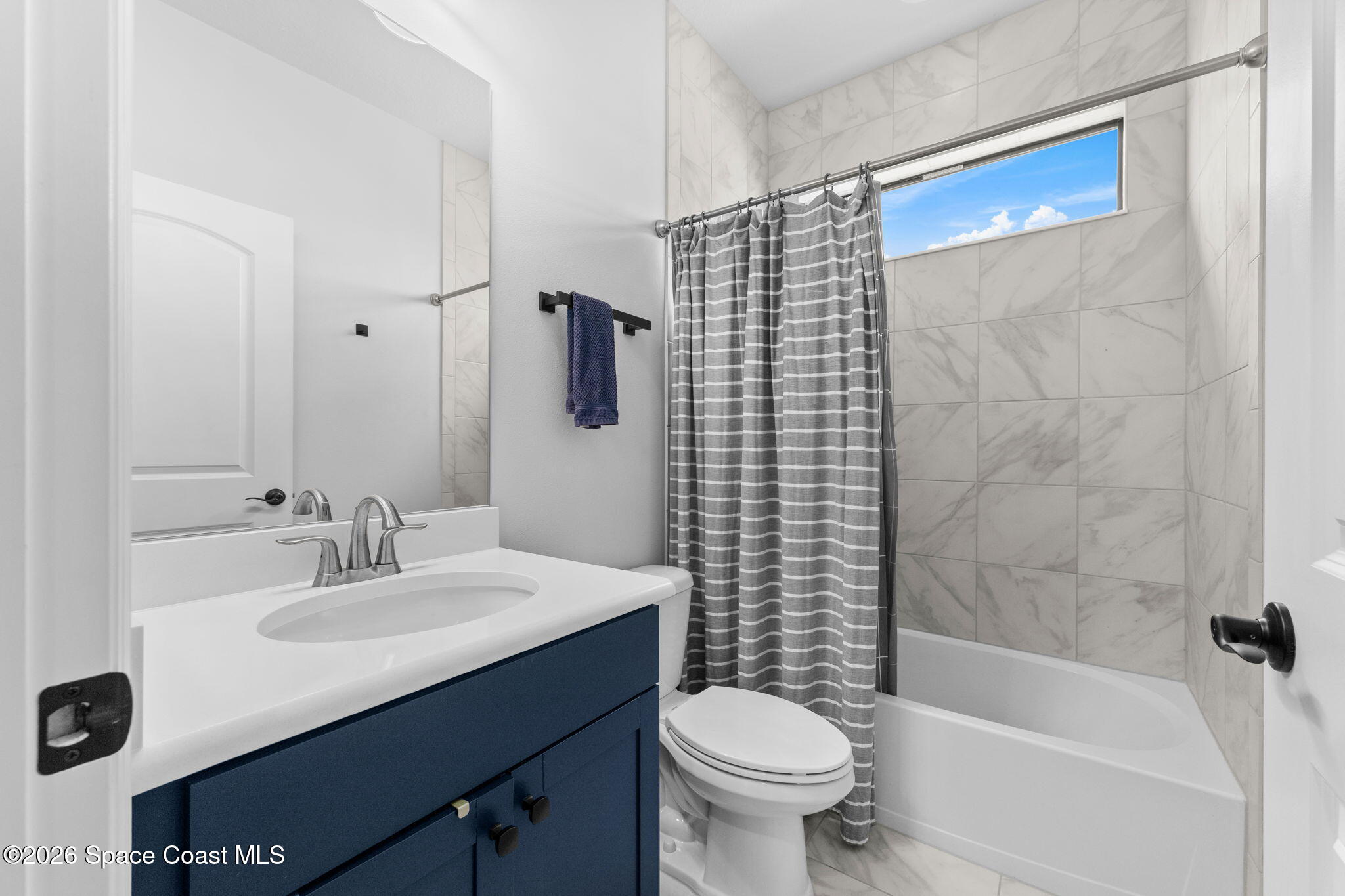 3236 Becorden Way Melbourne, FL 32940 - Photo 17 of 40 a bathroom with a sink a toilet and shower