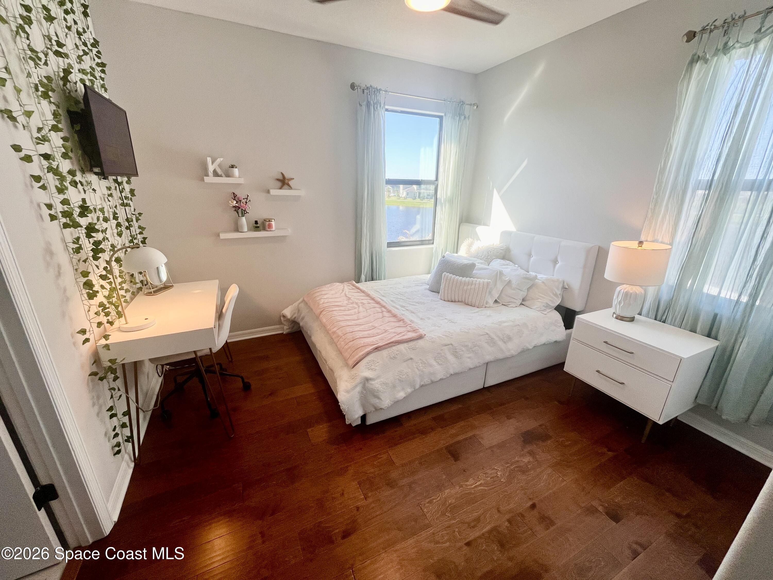 3236 Becorden Way Melbourne, FL 32940 - Photo 18 of 40 a bedroom with a bed window and a couch