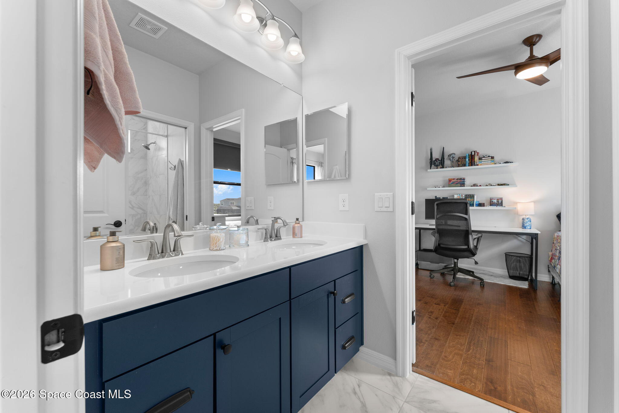 3236 Becorden Way Melbourne, FL 32940 - Photo 19 of 40 a en suite bathroom with a sink double vanity and a mirror