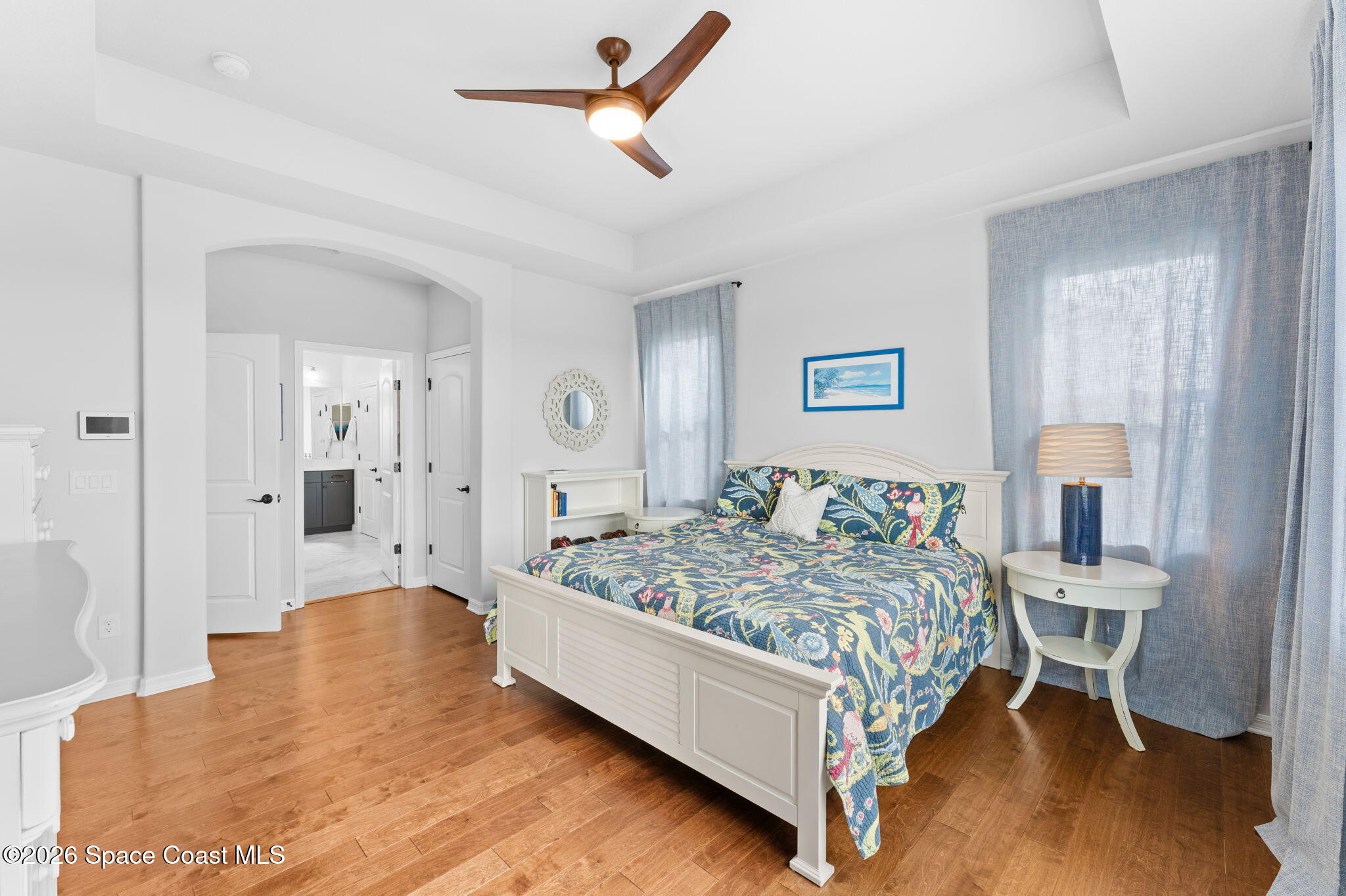 3236 Becorden Way Melbourne, FL 32940 - Photo 20 of 40 a bedroom with a bed a table and painting