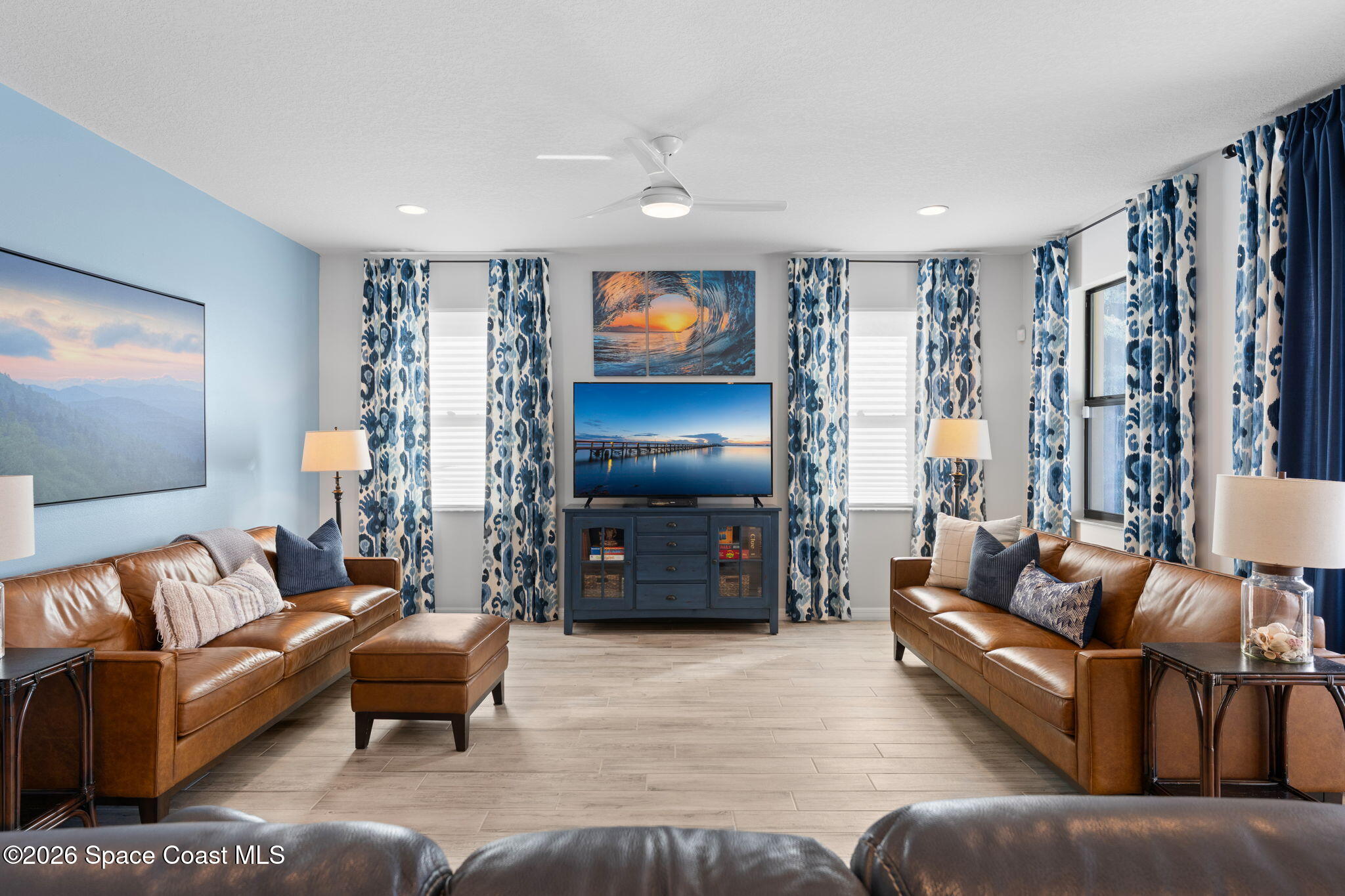 3236 Becorden Way Melbourne, FL 32940 - Photo 26 of 40 a living room with furniture and a flat screen tv
