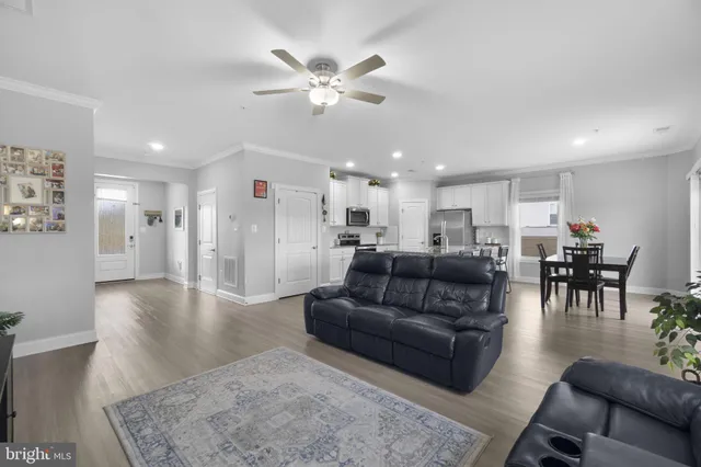 a living room with furniture and kitchen view
