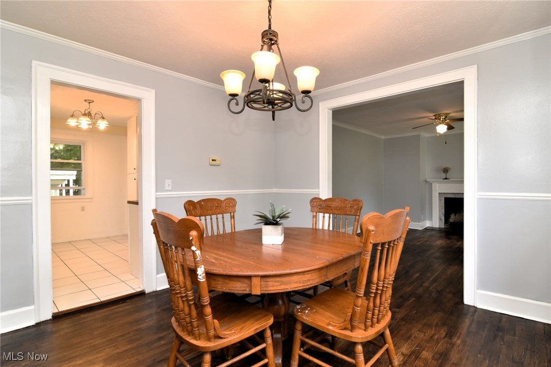 1683 Sunview Road Cleveland, OH 44124 - Photo 4 of 35 Dining room with ceiling fan with notable chandelier, ornamental molding, and dark hardwood / wood-style flooring