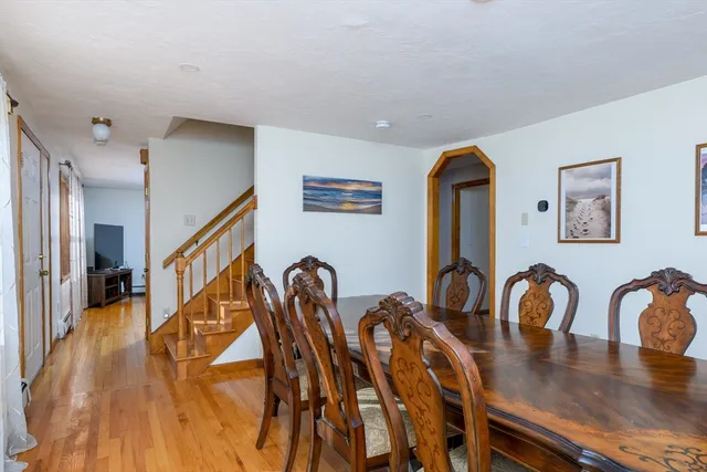 a dining room with furniture and wooden floor