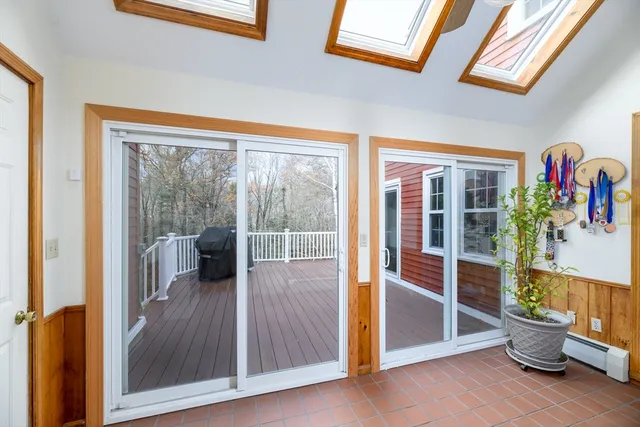 a view of a room with wooden floor and windows