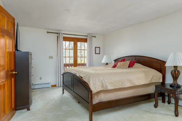 a bed sitting in a bedroom next to a window