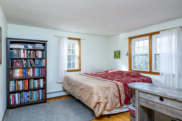 a bedroom with a bed and a book shelf