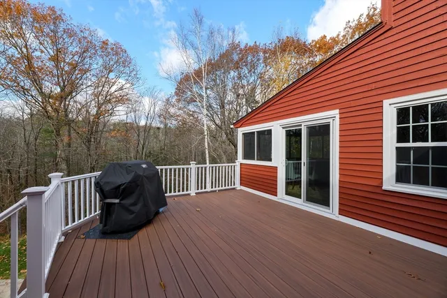 a view of a deck with couches table and chairs and wooden floor