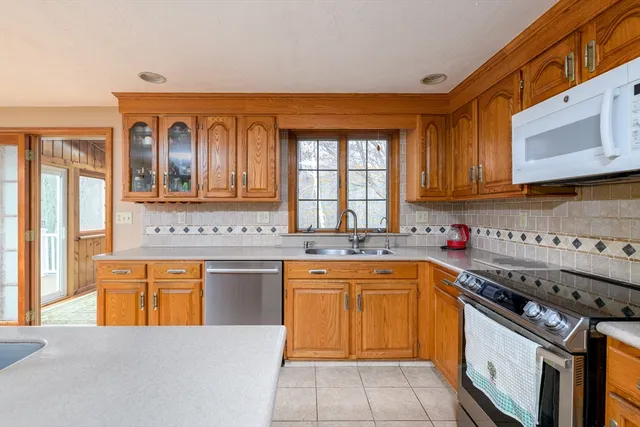 a kitchen with stainless steel appliances granite countertop a stove sink and cabinets