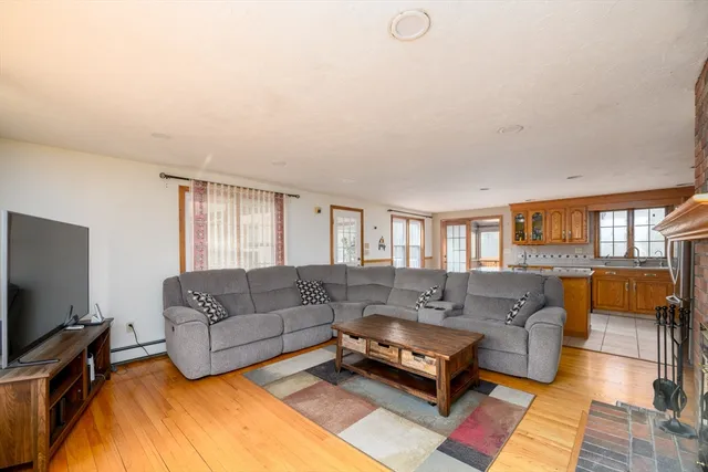 a living room with furniture a flat screen tv and a window