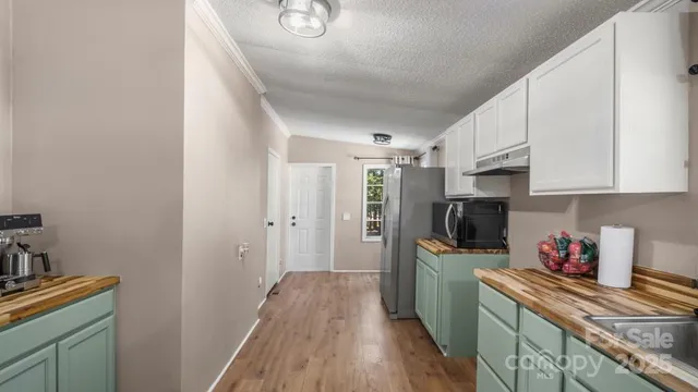 a kitchen with stainless steel appliances a refrigerator and a stove