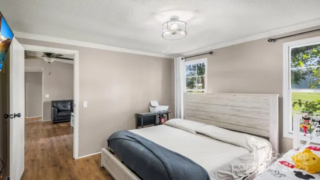 a bedroom with baby crib and windows