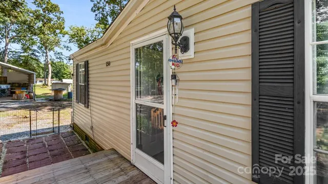 a view of backyard with deck and seating space