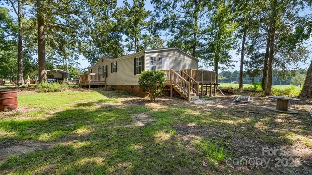 a view of a backyard with a large tree