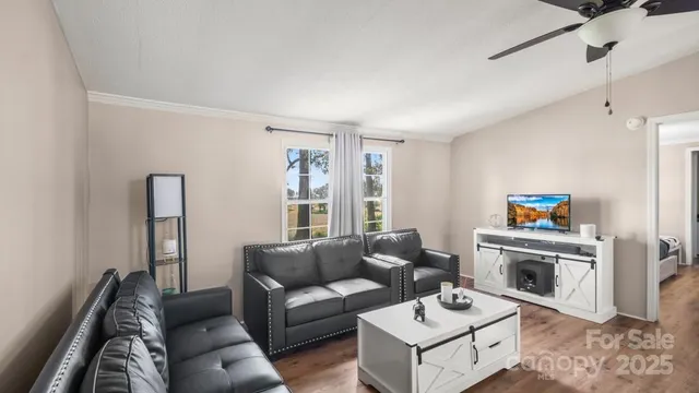 a living room with furniture and a wooden floor